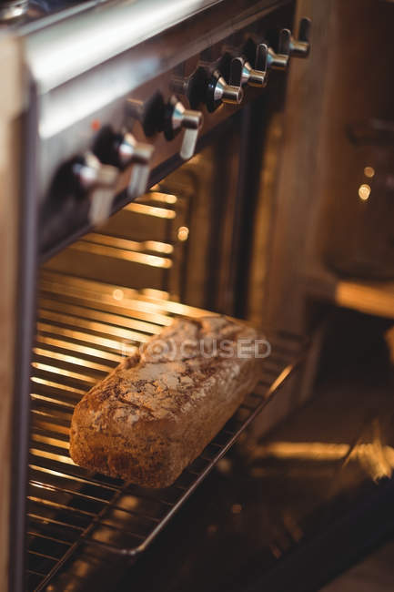 Baked bread in oven at home — Stock Photo