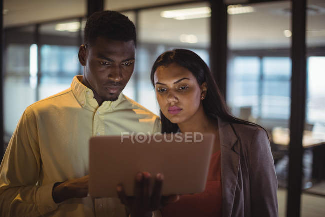 Empresario y un colega trabajando sobre el ordenador portátil en la oficina - foto de stock