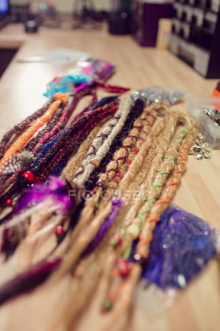 Close-up of artificial dreadlocks on desk in shop — Stock Photo