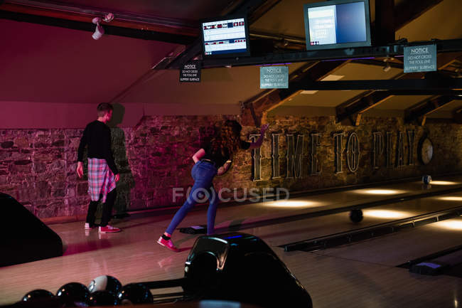 Friends playing bowling in bar — Stock Photo