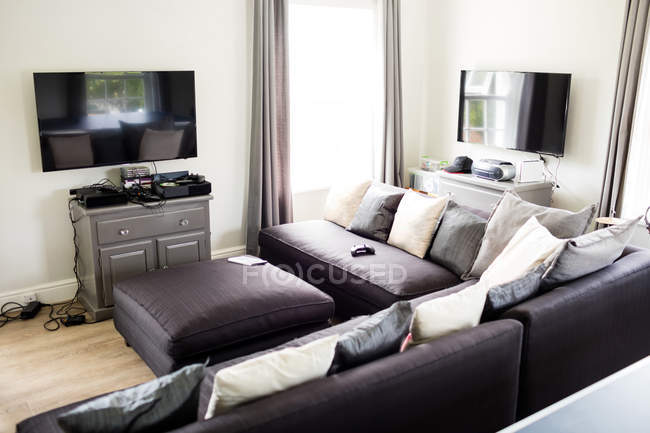 Empty living room with sofa and television at home — Stock Photo