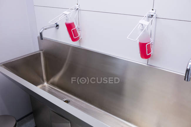 Primer plano del fregadero con líquido de mano en el hospital - foto de stock