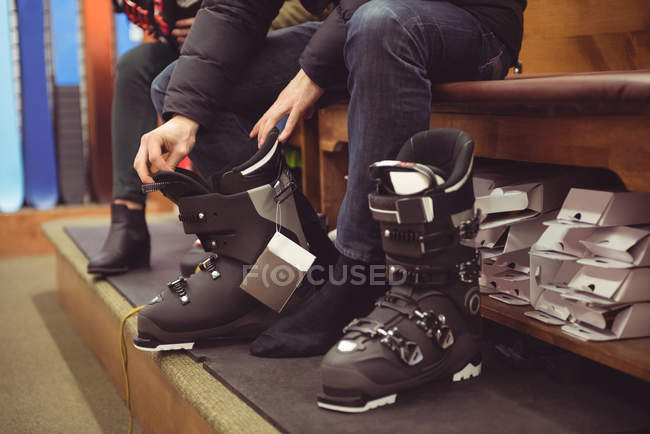 Close-up of man wearing a ski boots in a shop — Stock Photo
