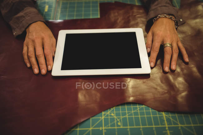 Sección media de la artesana utilizando tableta digital en el taller - foto de stock