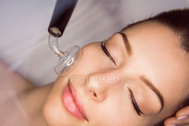 Close-up of dermatologist performing laser hair removal on patient face in clinic — Stock Photo