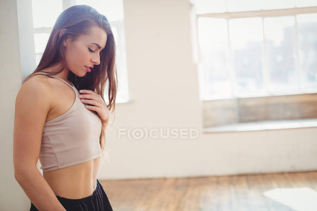 Mulher bonita pensativo de pé no estúdio de dança — Fotografia de Stock