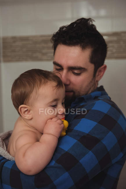 Father holding his baby in bathroom at home — Stock Photo