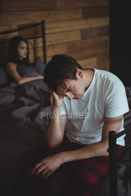 Расстроенная пара, игнорирующая друг друга после драки на кровати в спальне — стоковое фото