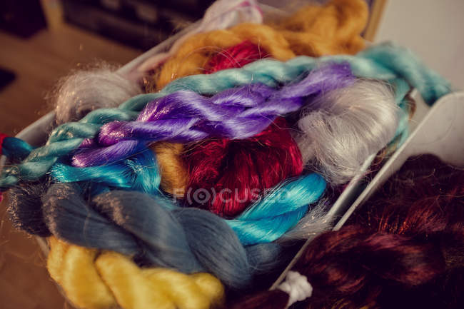 Close-up of artificial dreadlocks materials on desk in shop — Stock Photo