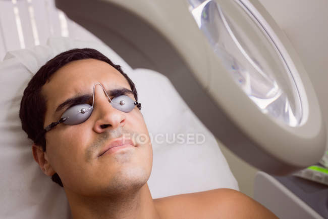 Patient wearing laser protective glasses in clinic — Stock Photo