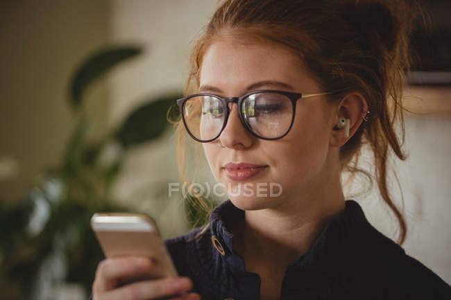 Beautiful woman using mobile phone — Stock Photo