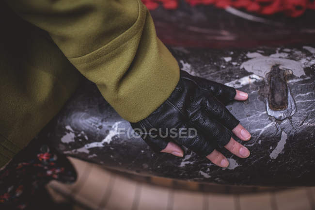 Close-up of female hand on rustic surface — Stock Photo