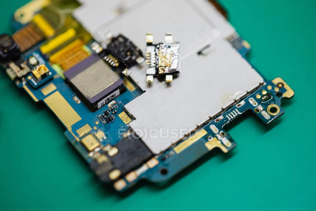 Close-up of disassembled mobile phone components in a repair centre — Stock Photo