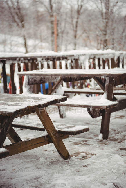 Tables with ice and snow on them at a ski resort — Stock Photo