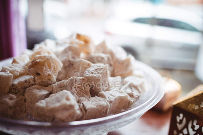 Close-up of turkish sweets arranged in tray at counter in shop — Stock Photo