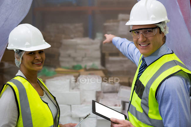 Portrait of technicians with digital tablet at industrial factory — Stock Photo