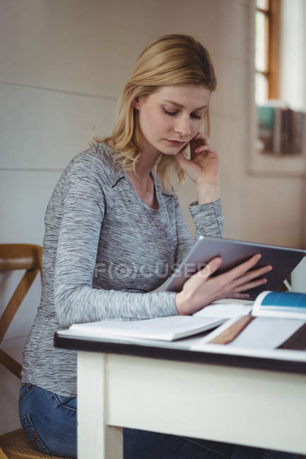 Mulher bonita usando tablet digital na sala de estar em casa — Fotografia de Stock