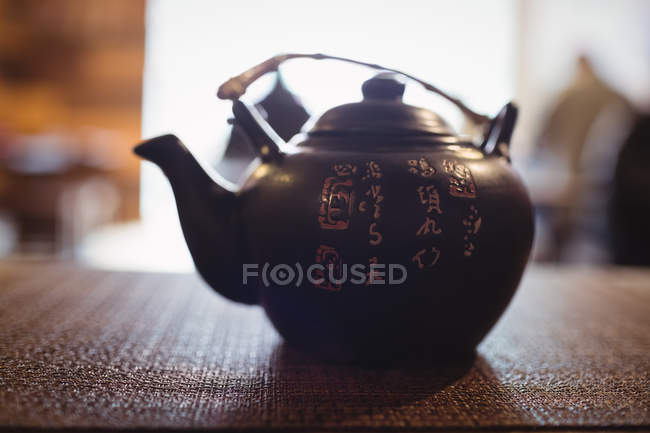 Traditional Japanese sake teapot on table in restaurant — Stock Photo