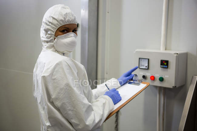 Portrait of technician operating machine at meat factory — Stock Photo