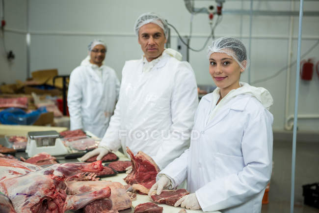 Retrato de açougueiros em pé na fábrica de carne — Fotografia de Stock