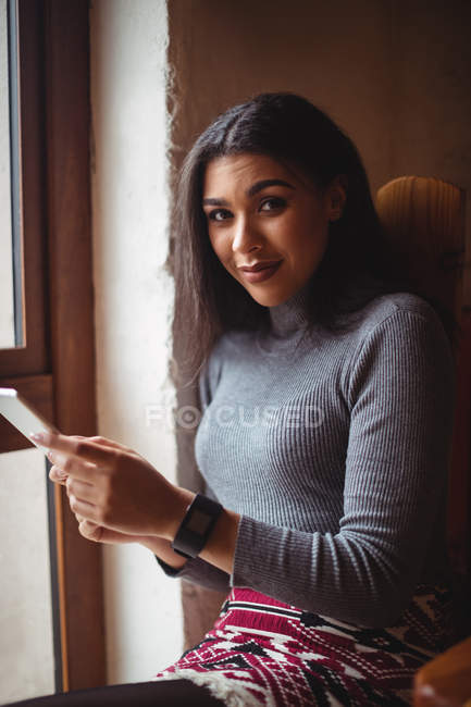 Retrato de mujer hermosa usando tableta digital en la cafetería - foto de stock
