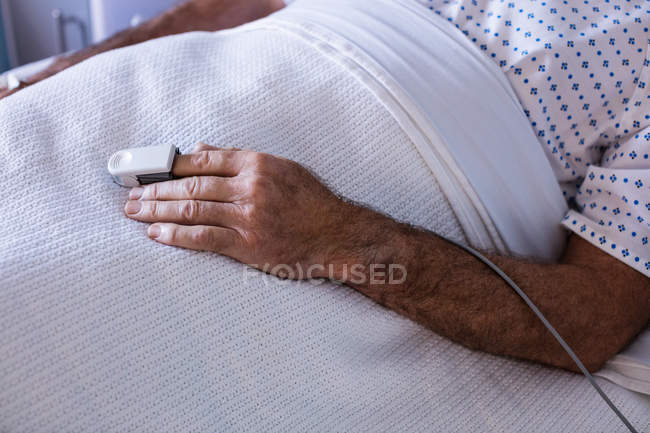 Finger clip on patients hand to monitor pulse in the hospital — Stock Photo