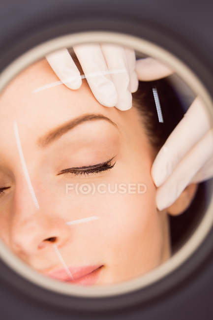 Hands of dermatologist examining female patient skin in clinic — Stock Photo