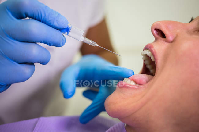 Close-up of doctor giving injection to the female patient — Stock Photo