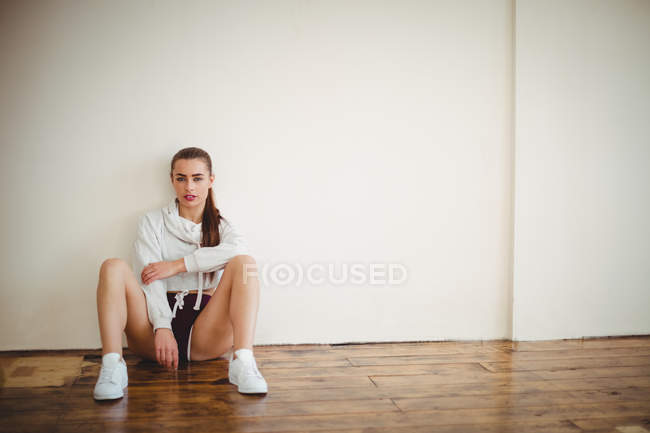 Молодая красивая женщина сидит в студии — стоковое фото