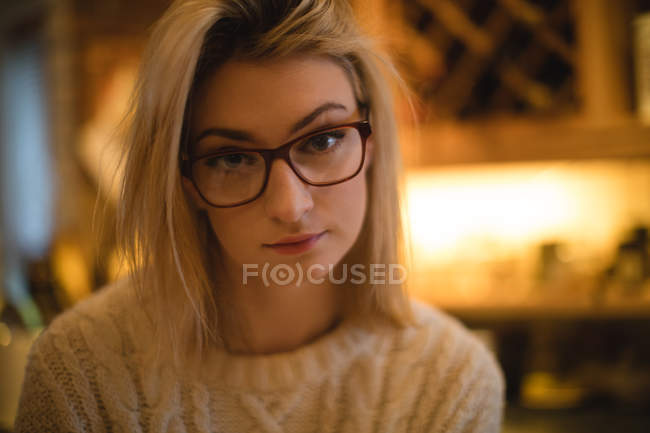 Portrait of thoughtful woman in kitchen at home — Stock Photo