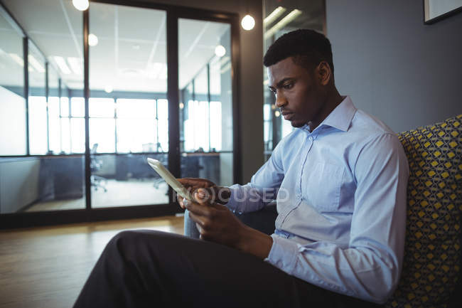 Portrait of businessman using digital tablet in office — Stock Photo