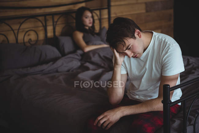 Upset couple ignoring each other after fight on bed in bedroom — Stock Photo