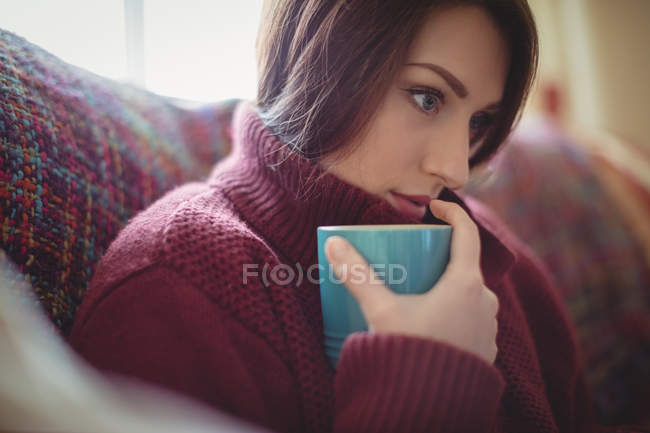 Красива жінка тримає чашку кави вдома — стокове фото