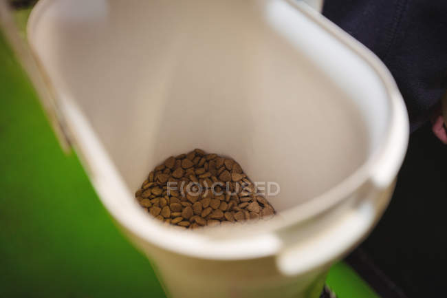 Close-up of dog food in plastic container — Stock Photo