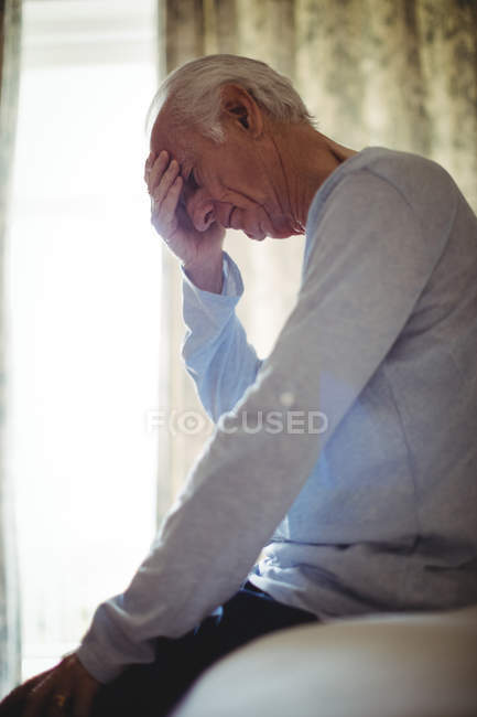 Worried senior man in bedroom at home — Stock Photo
