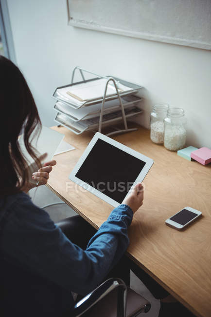 Business executive using digital tablet in office — Stock Photo