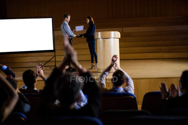 Female business executive receiving award at conference center — Stock Photo
