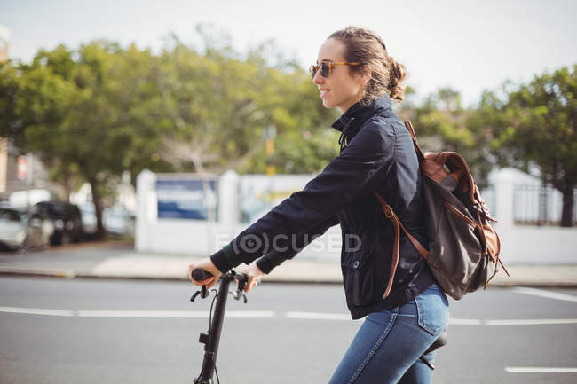 Frau mit Fahrrad auf der Straße — Stockfoto