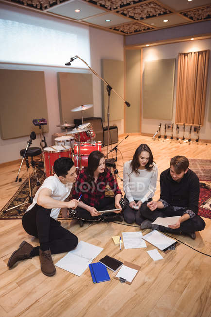 Team of musicians composing tune in recording studio — Stock Photo