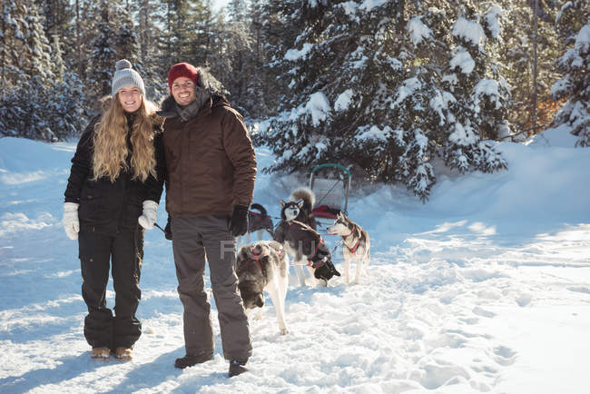 Портрет посміхаючись mushers стоячи з саней на сніжний пейзаж — стокове фото
