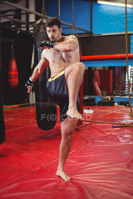 Boxer doing stretching exercise in fitness studio — Stock Photo