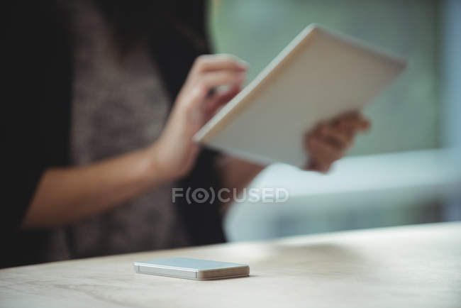 Mobile phone on table in office — Stock Photo