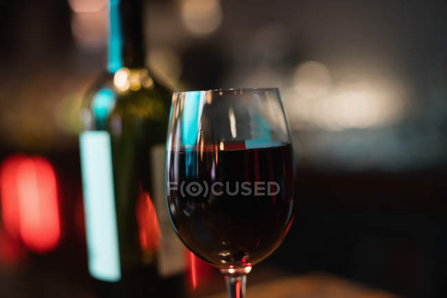 Close-up of red wine glass on bar counter at bar — Stock Photo
