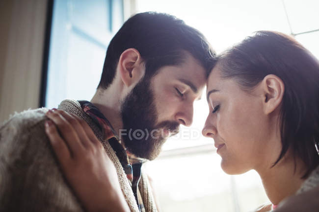 Close-up of young couple embracing each other at home — Stock Photo