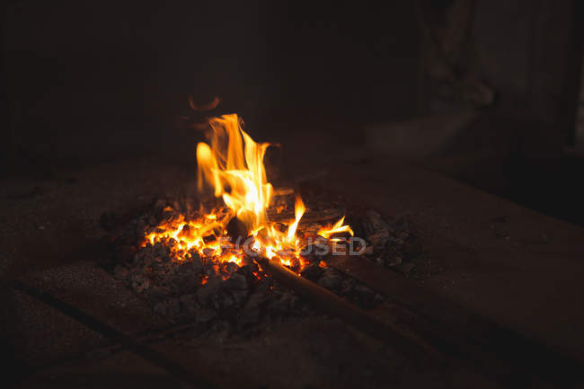 Close-up of iron rod heated in fire at workshop — Stock Photo