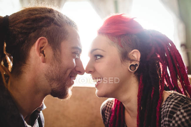 Romantic hipster couple looking at each other in house — Stock Photo