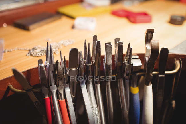 Close-up of various pliers arranged on workbench in workshop — Stock Photo