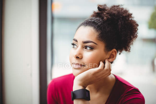 Close-up of thoughtful woman with hand on chin at restaurant — Stock Photo