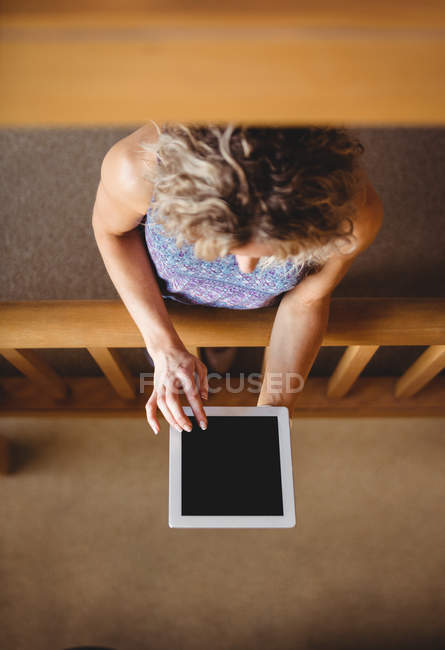 High angle view of Woman using digital tablet in cafeteria — Stock Photo