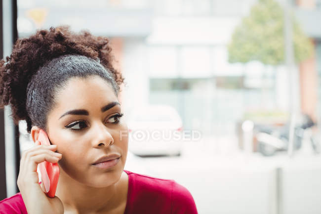 Close-up of woman talking on phone at restaurant — Stock Photo